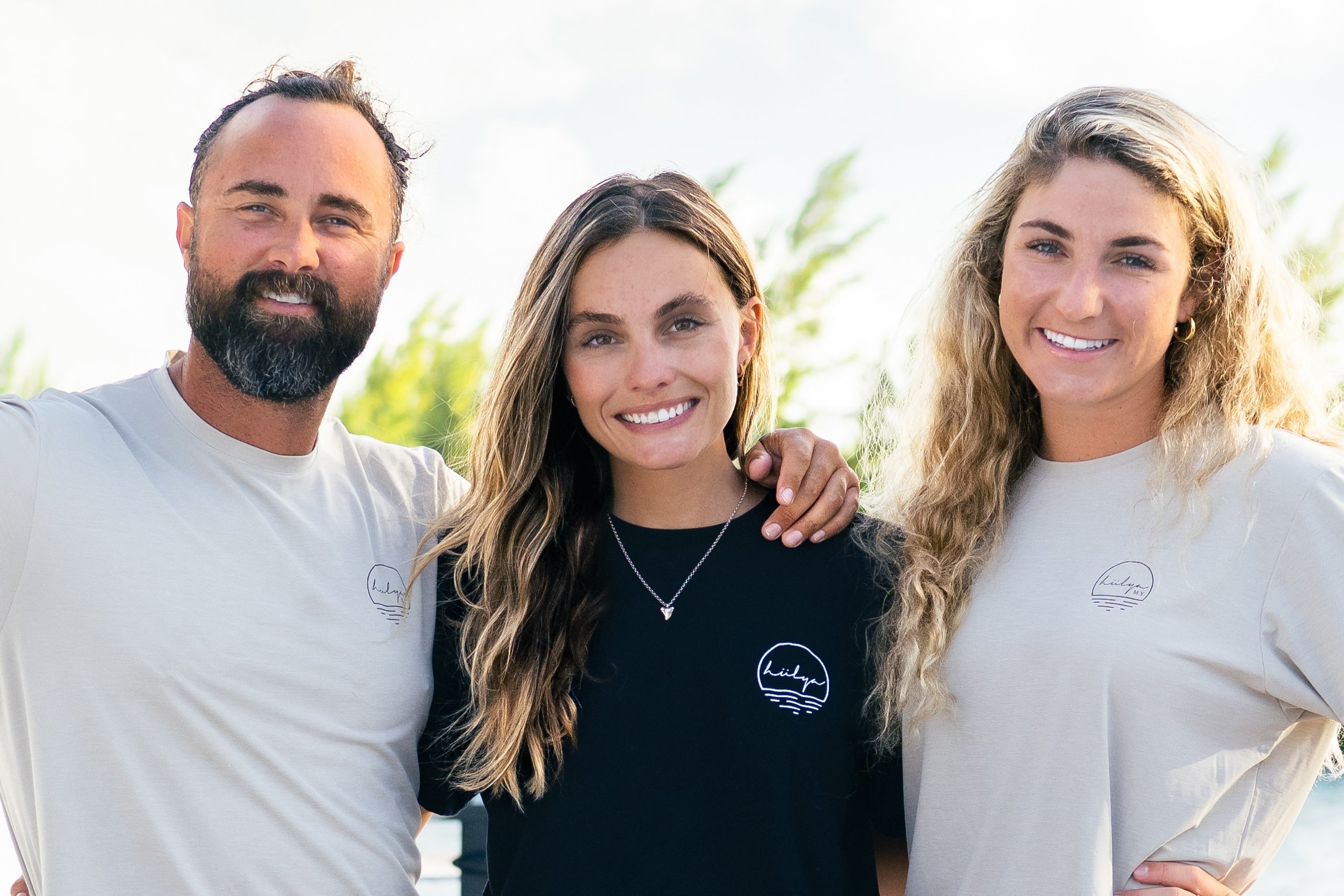 John, Hannah, and crew together in branded Hülya shirts outdoors