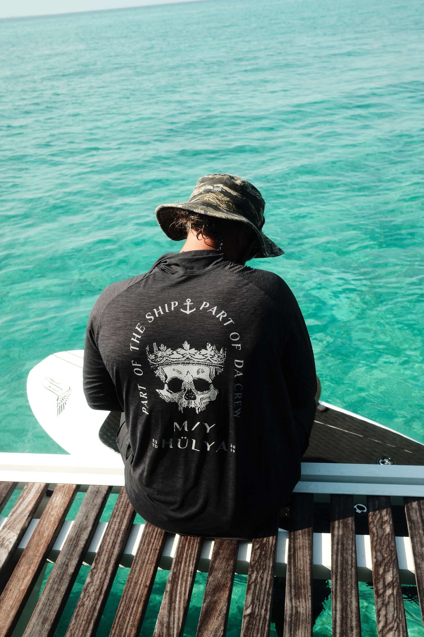 Crew in Hülya skull shirts on swim platform