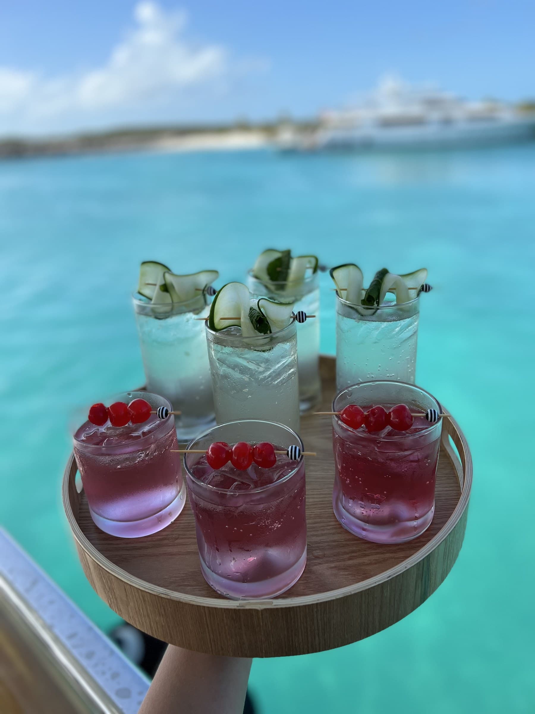 Six craft cocktails on turquoise — welcome drinks