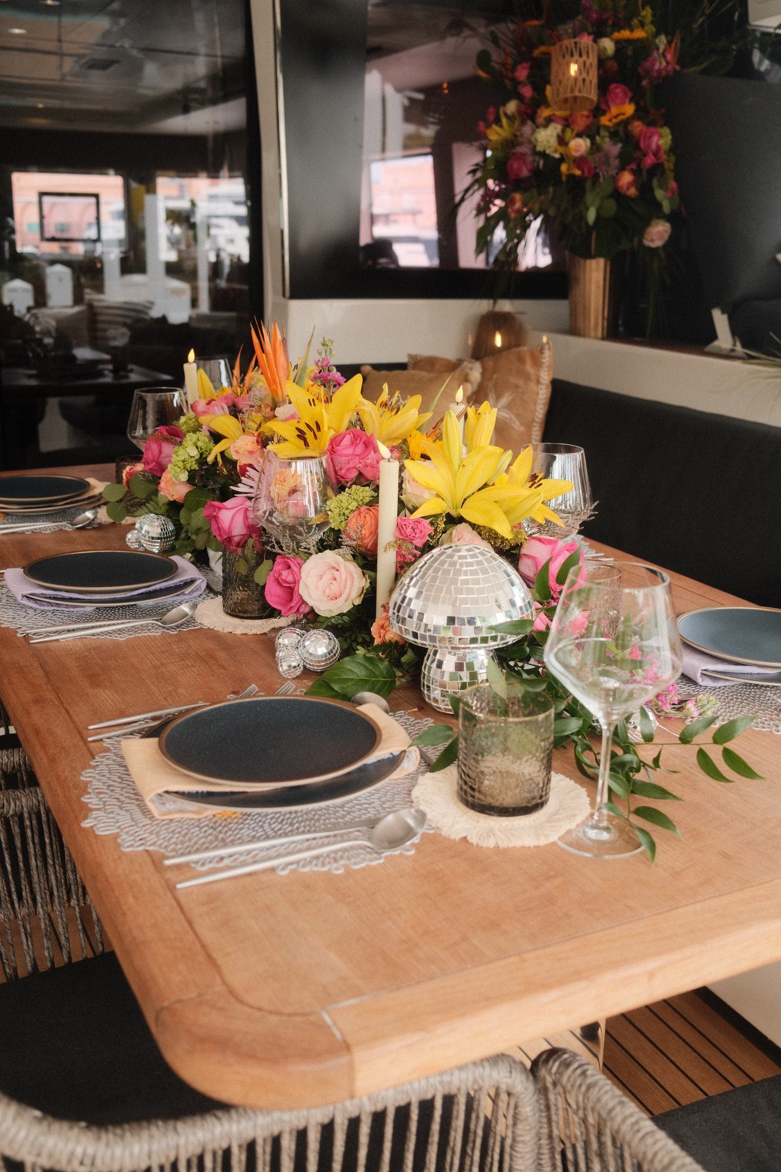 Floral table with disco-ball accents — arrival setup