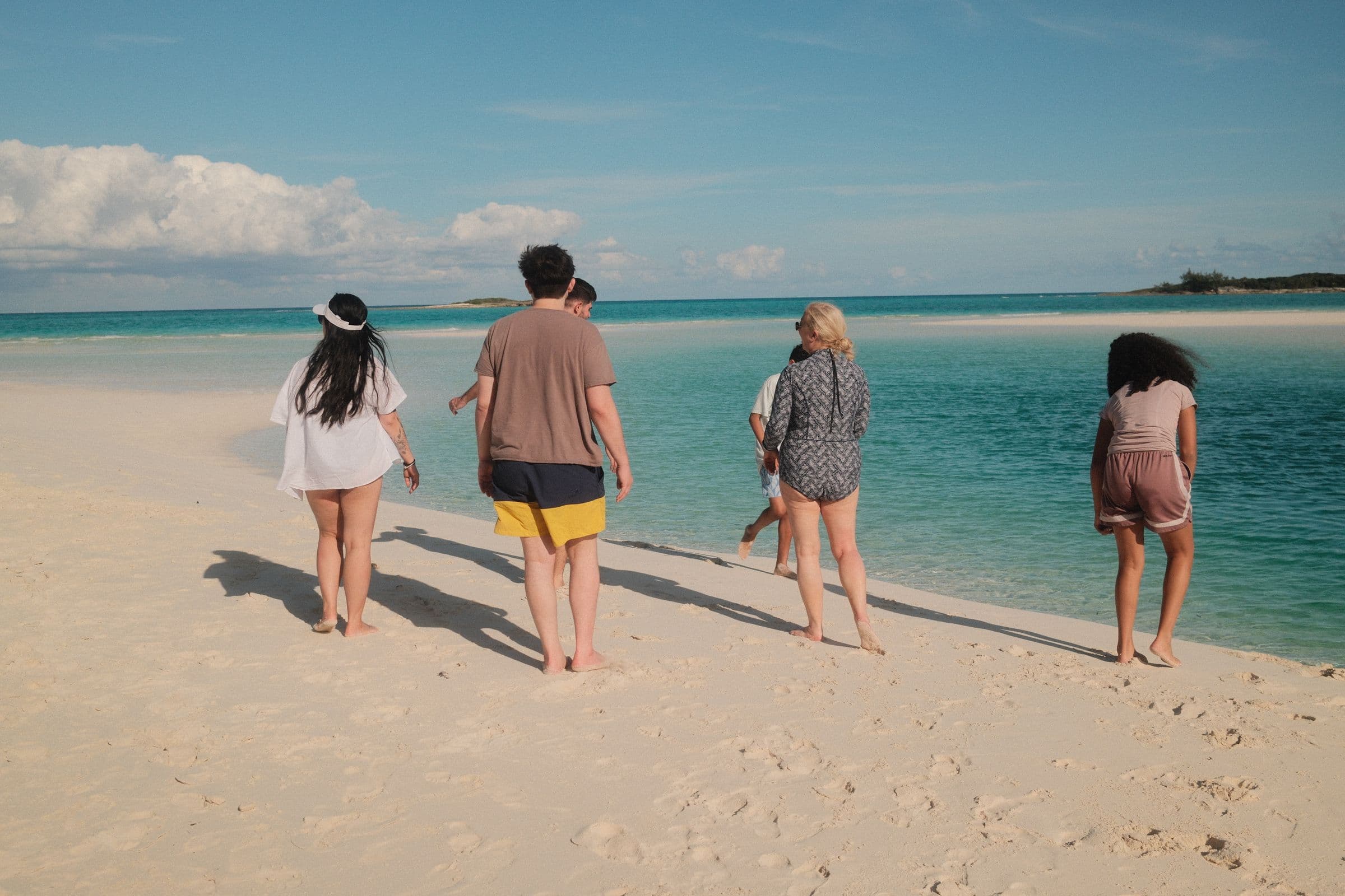 Family walking toward the water at golden hour