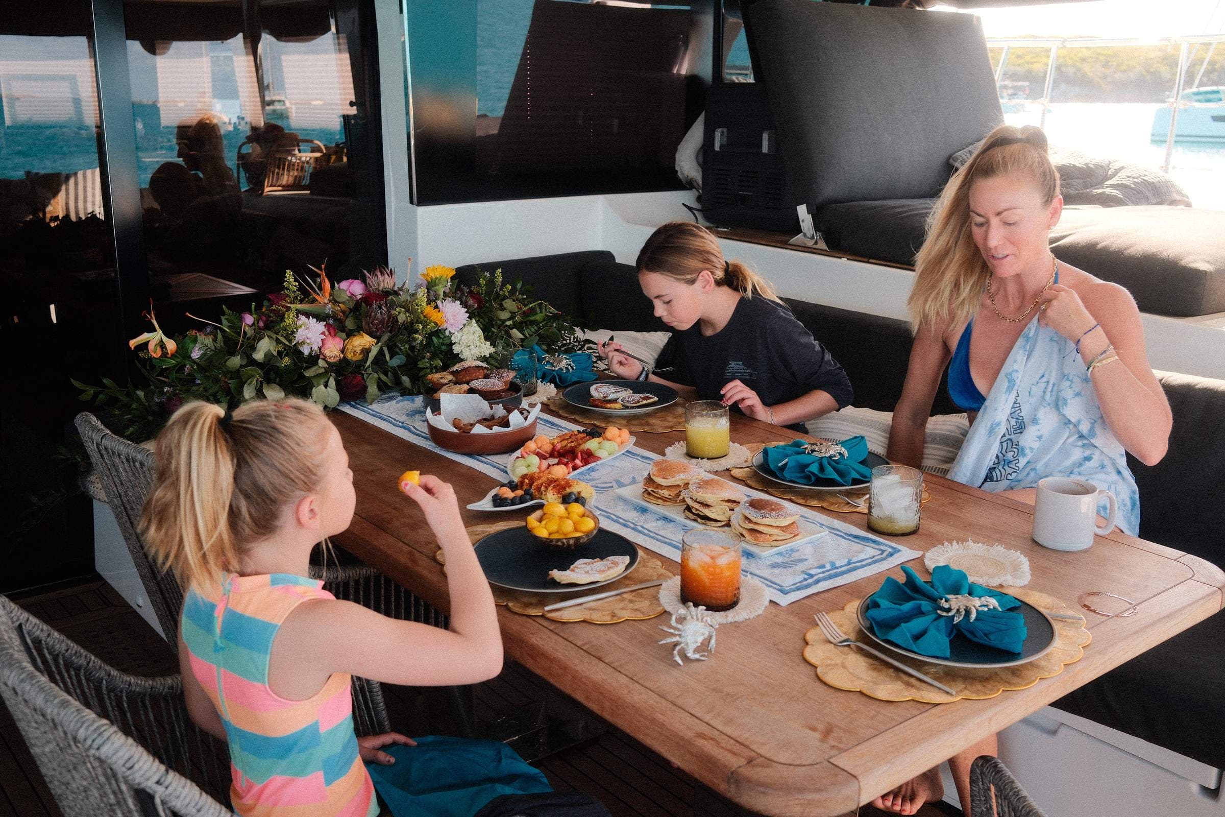 Mother and daughters at breakfast, golden morning light