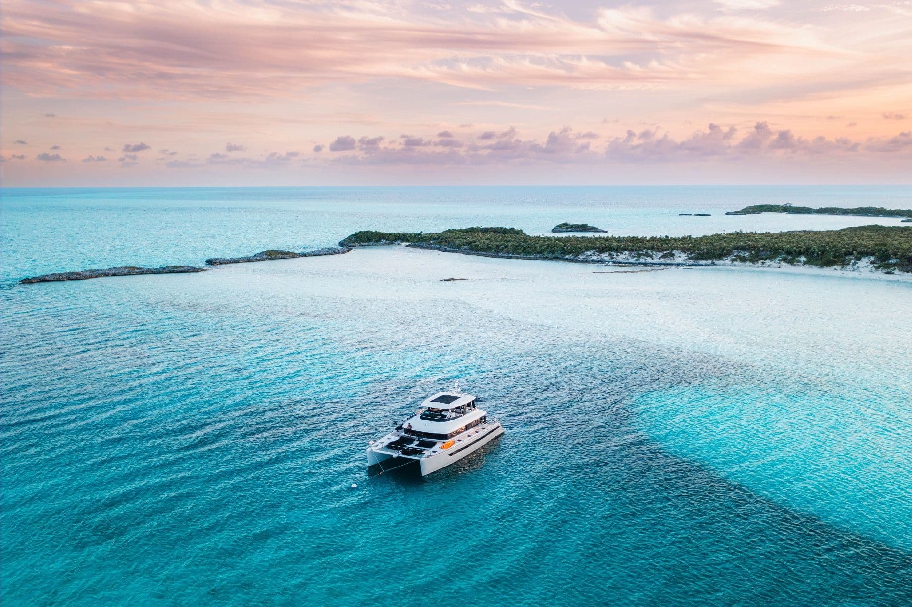 Aerial catamaran at sunset — Bahamian waters