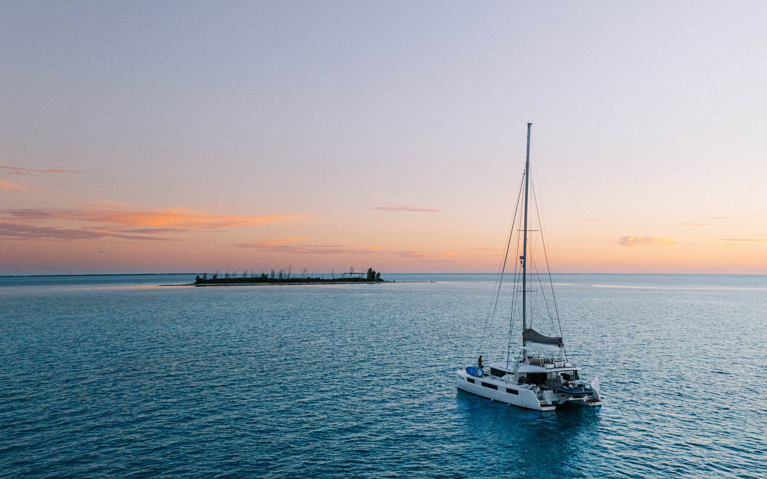 Aerial overhead of catamaran with full water toy deployment