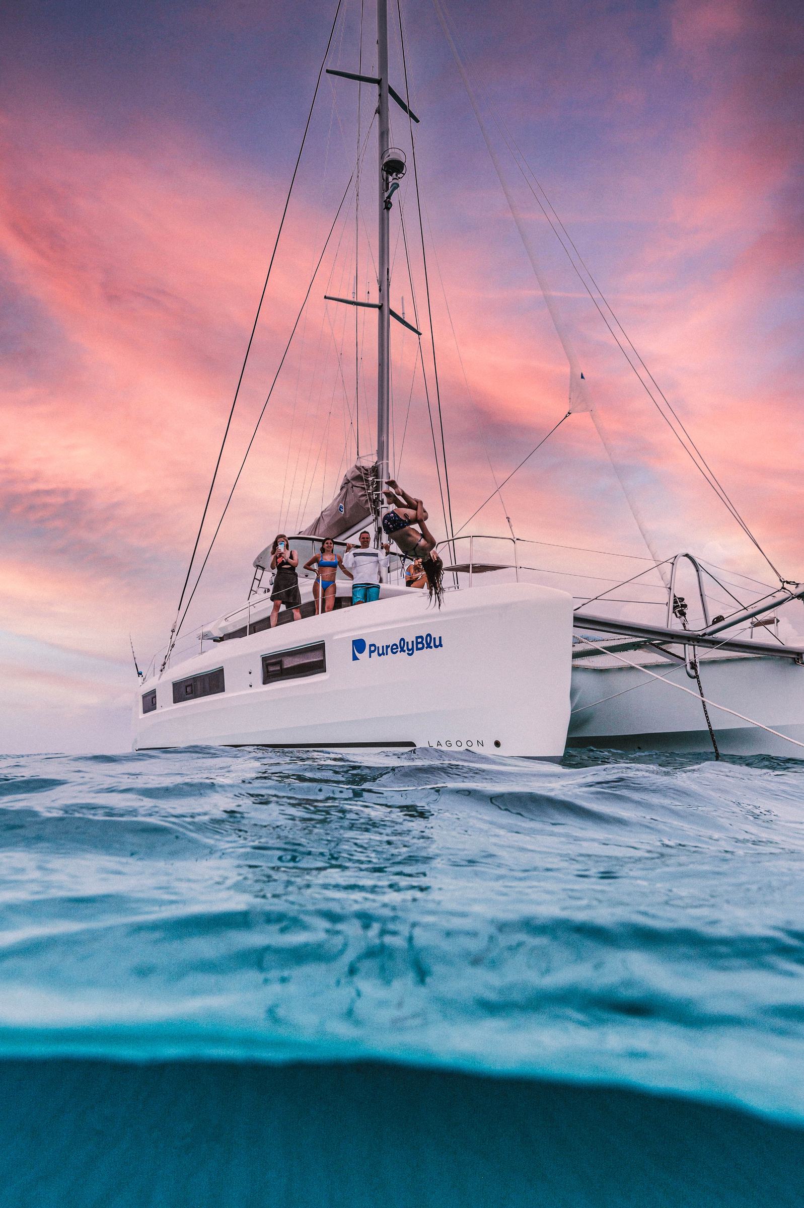 PurelyBlu — 2021 Lagoon 50 sailing catamaran at sunset, Exumas, Bahamas