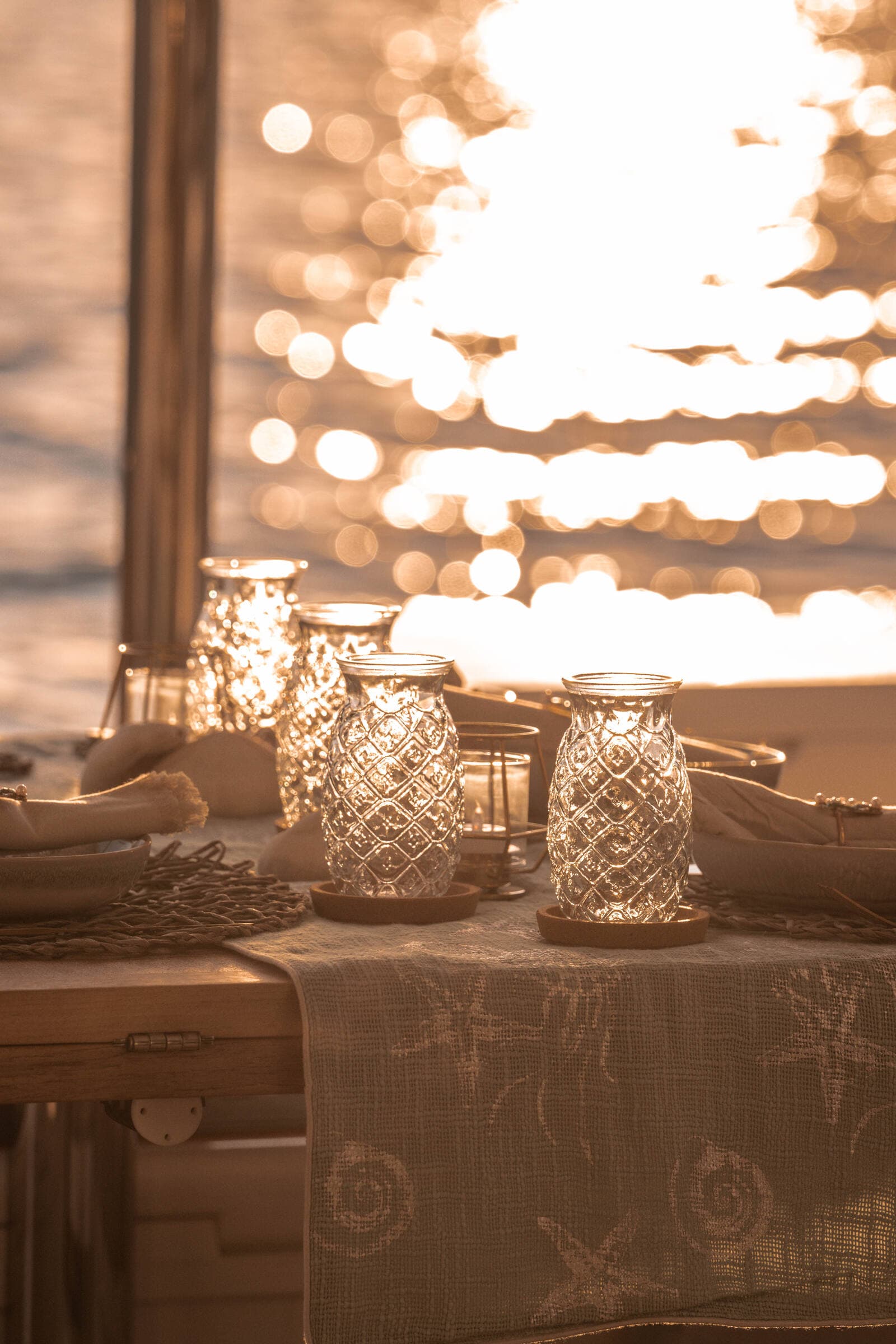 Pineapple lantern table at golden hour — charter revenue in practice