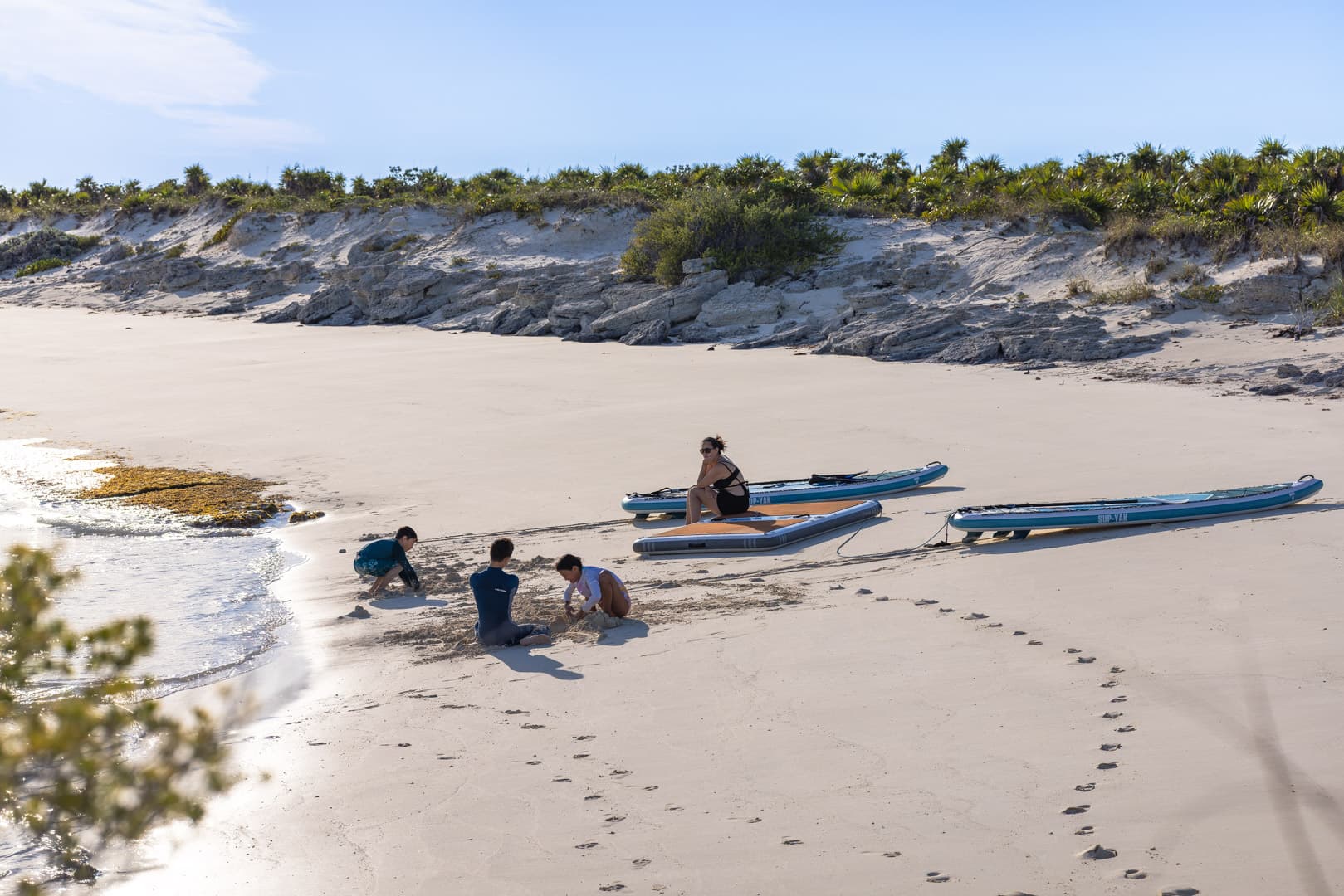 PurelyBlu's inflatable BOTE dock and paddleboards pulled up on an empty Exumas beach